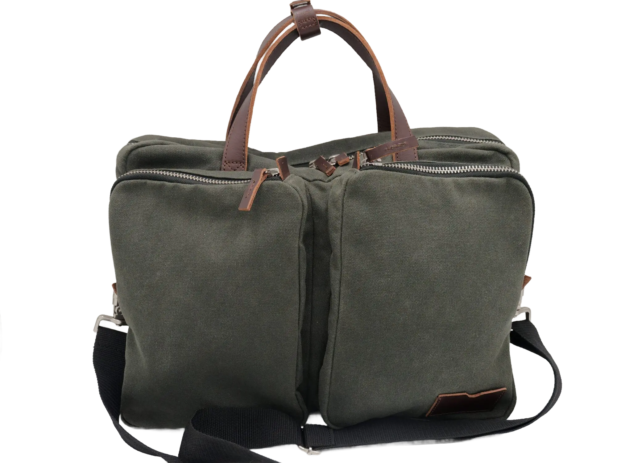 Front three-quarter view of the foliage green waxed canvas messenger bag with two zip compartments and brown leather carry handles