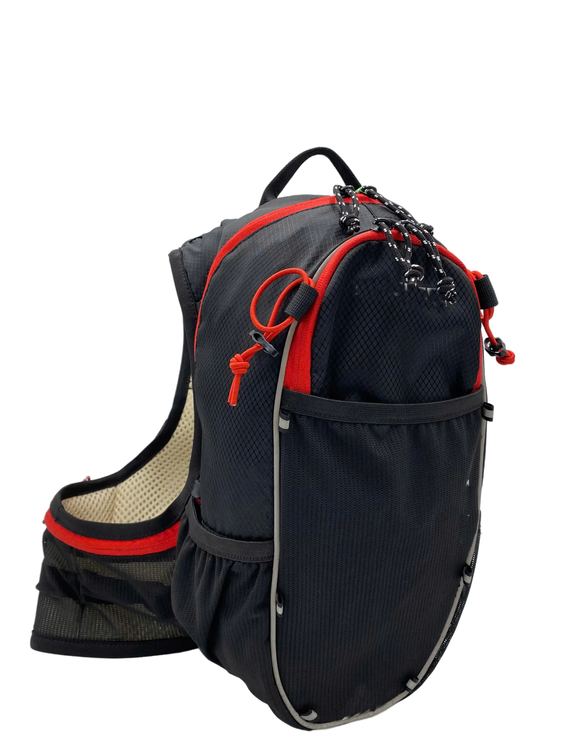 Three-quarter side view of the black ripstop hydration backpack with red accents, cord zipper pulls and beige mesh shoulder strap