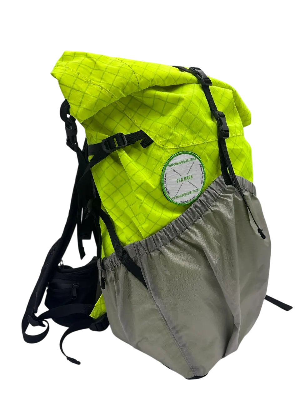 Front view of the 30L yellow X-Pac rolltop trekking backpack with grey lower section and round woven patch