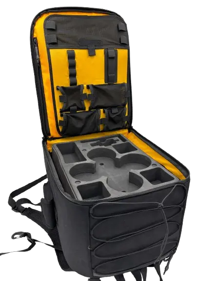 Black and yellow drone backpack with open main compartment revealing CNC-machined EVA foam dividers