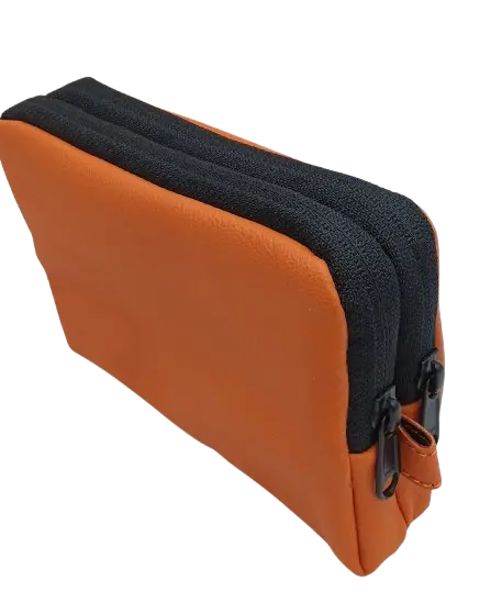 Angled side view of the tan leather organizer pouch showing two parallel black zip tracks along the top edge