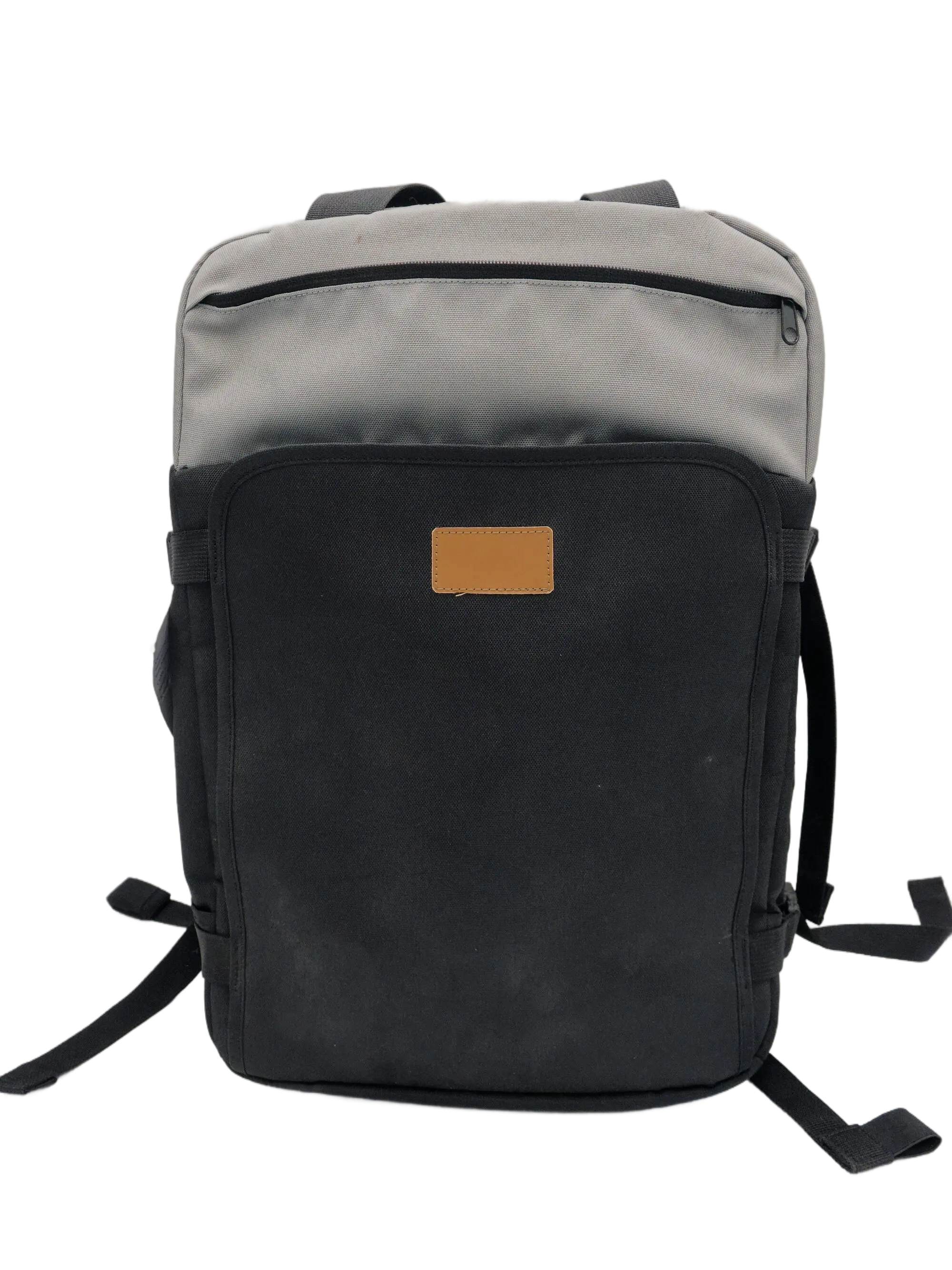 Front view of the two-tone grey and black recycled 600D nylon backpack with a tan leather patch on the lower panel