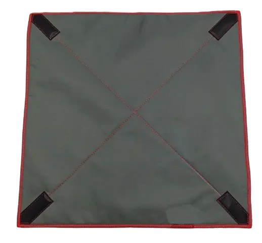 Flat lay of the grey woven outer face of the padded wrap with red bound edges, diagonal fold lines, and hook-and-loop corner tabs