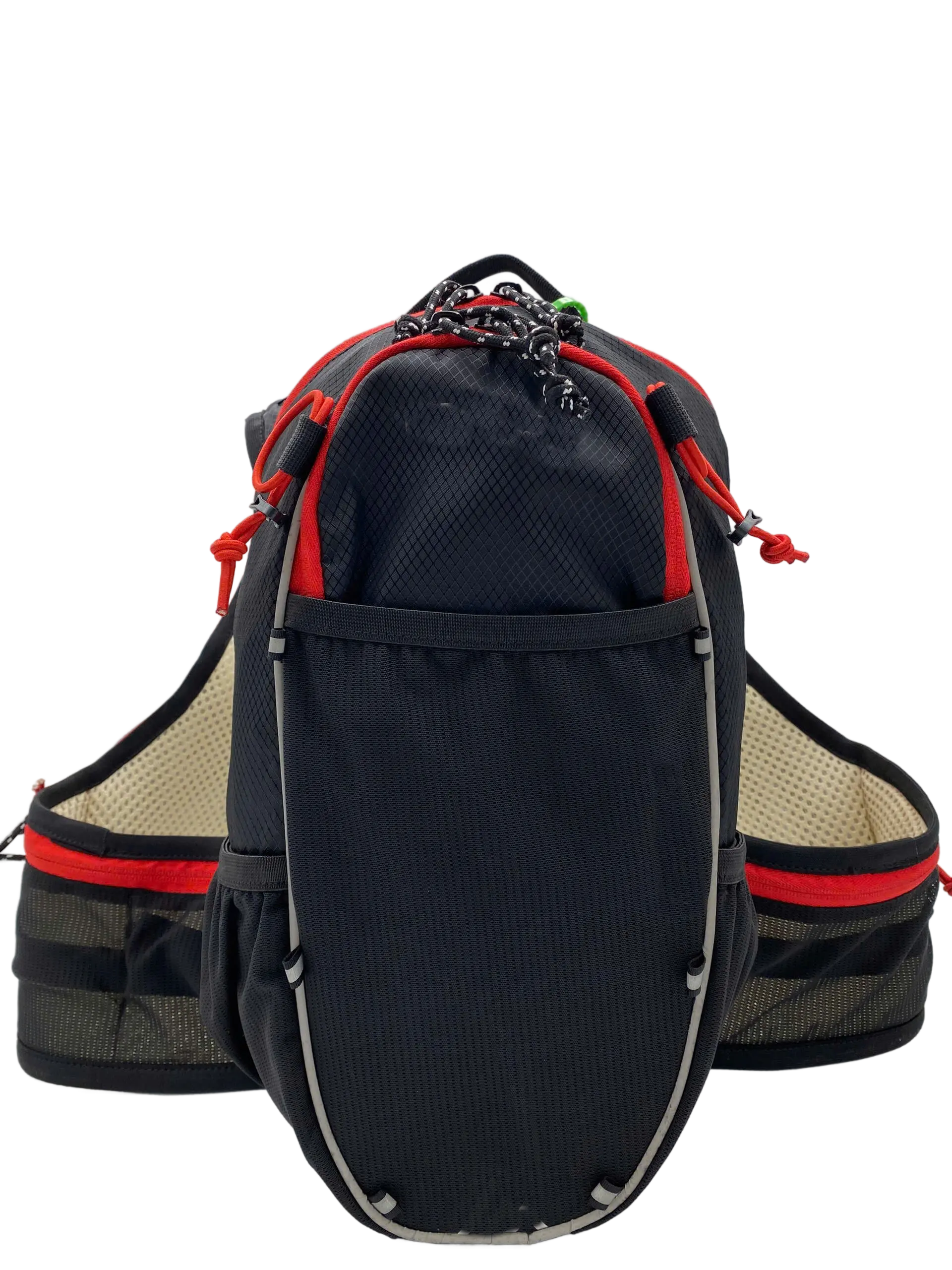 Front view of the black hydration trail backpack showing the main zippered pocket with red accents and reflective trim