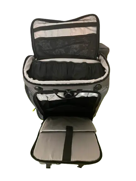 Front view of the carrier with top mesh compartment and lower access door open showing organized grey padded interior