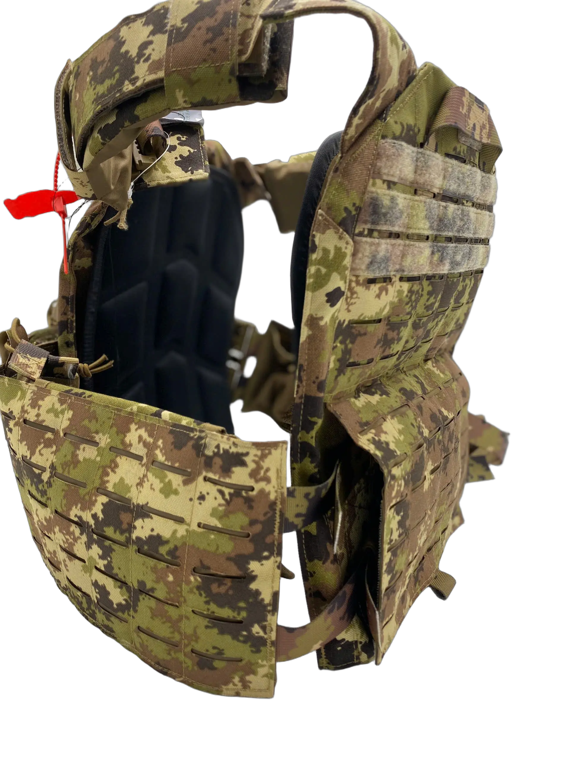 Side view of the camo plate carrier with open plate cavity exposing foam padding, red quick-release pull, and MOLLE side flap