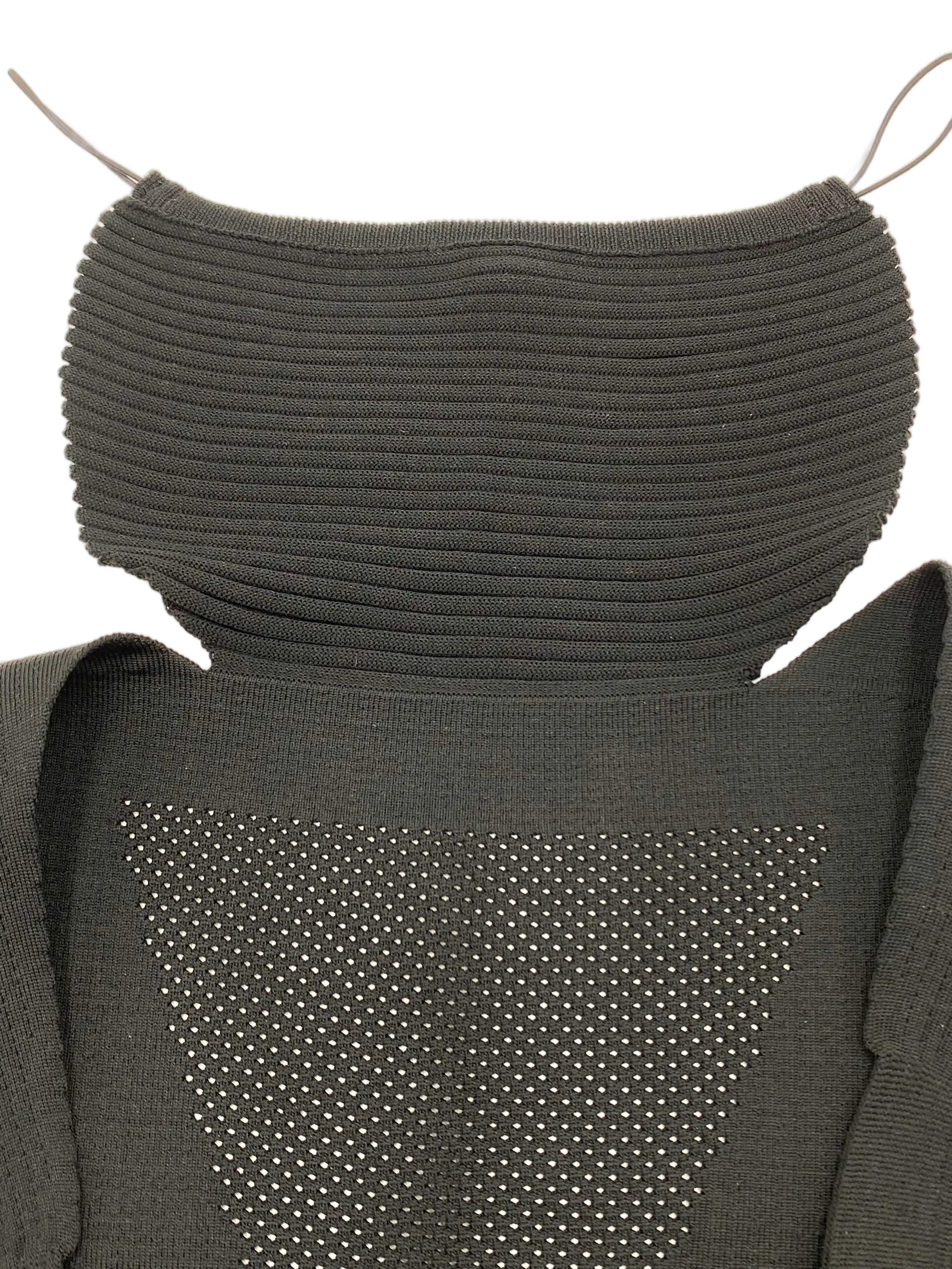 Top-down view of the baby carrier headrest with ribbed knit construction and perforated mesh ventilation zone below