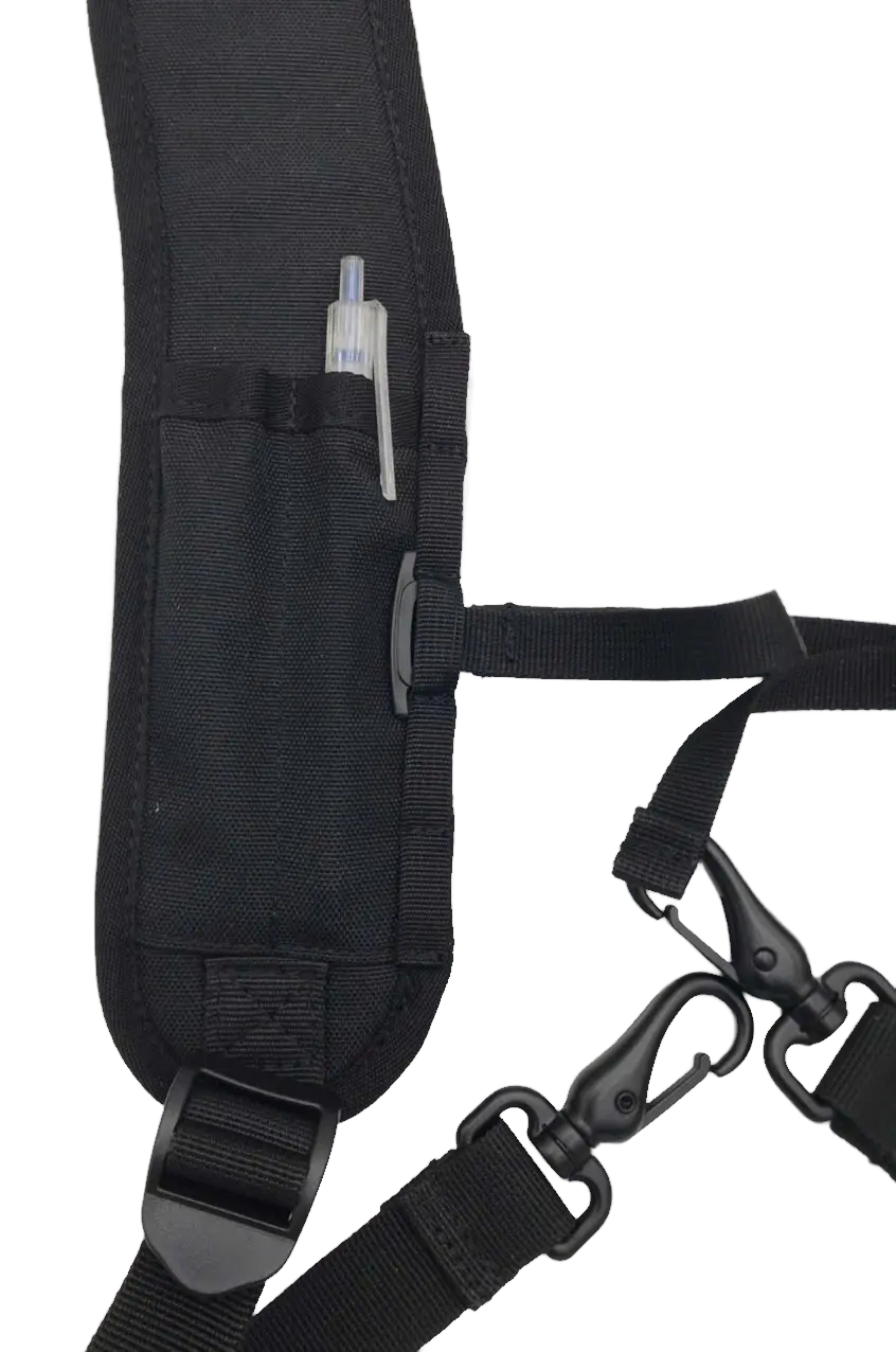 Close-up of the shoulder strap pen sleeve with a marker inserted, showing webbing loops and carabiner clip hardware