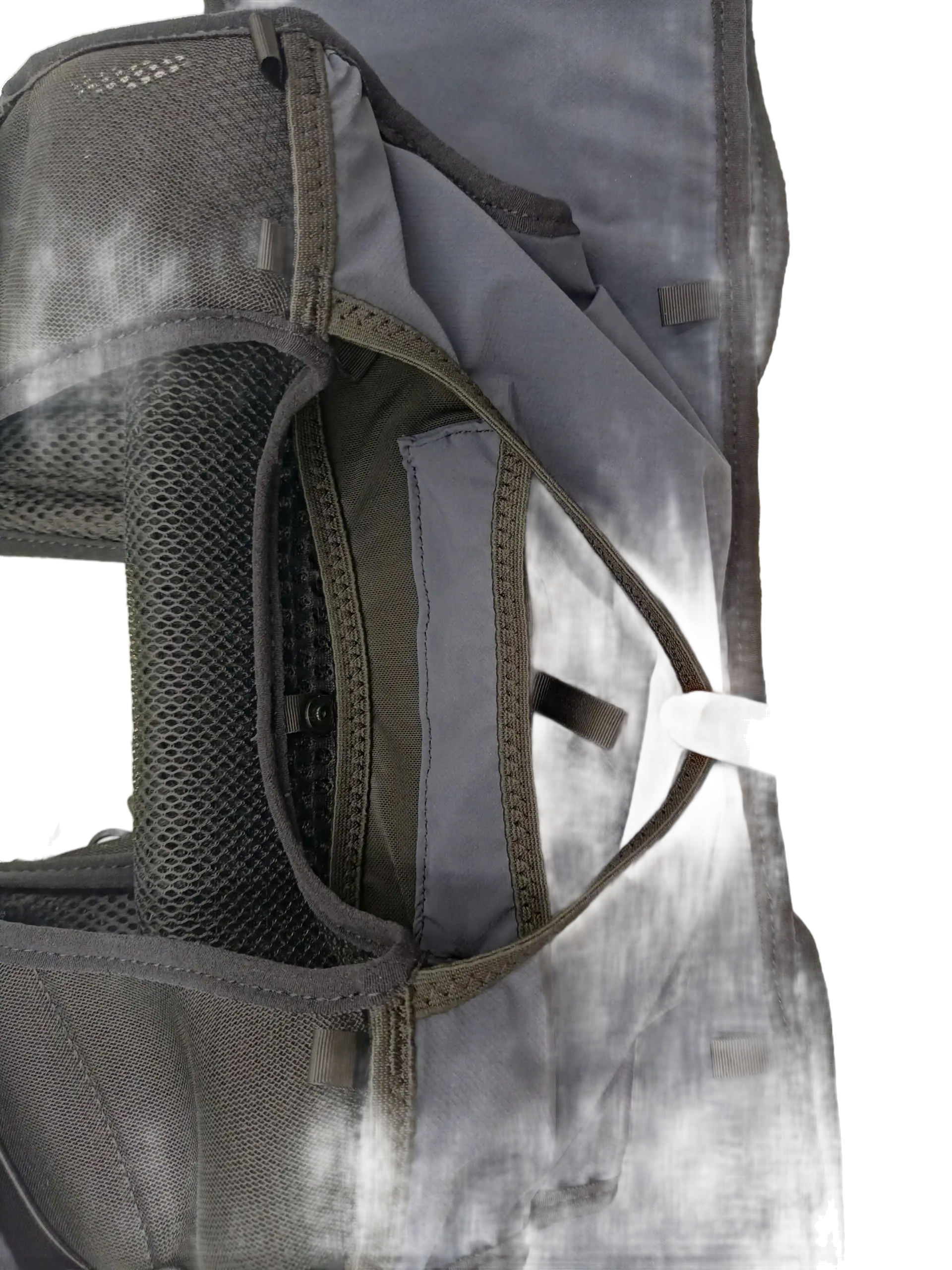 Close-up of the open rear storage compartment showing internal mesh divider and hydration sleeve access