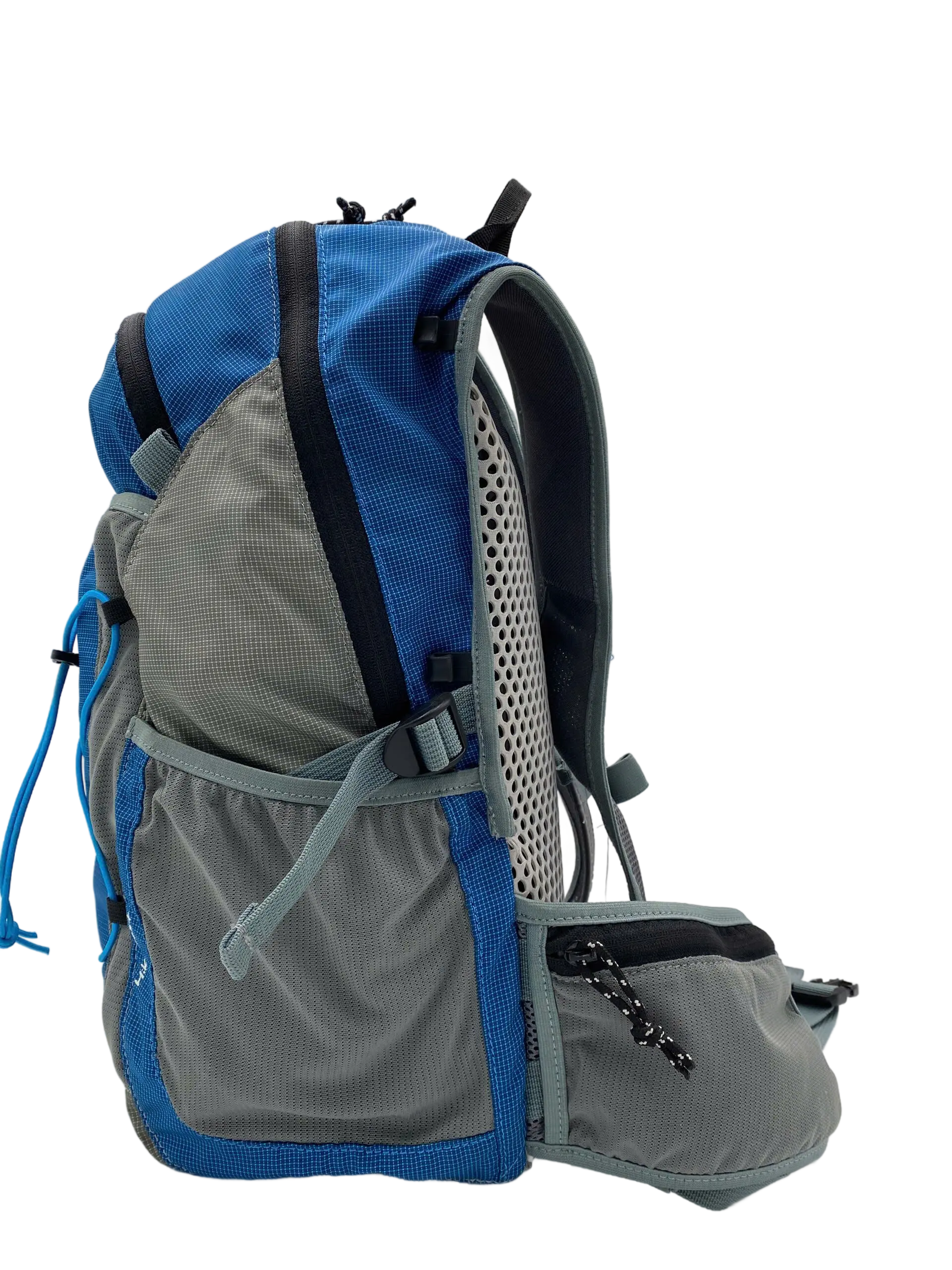 Side profile of the 20L hiking backpack showing stretch side pocket, mesh back section and structured top handle