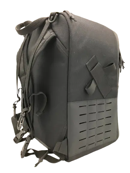 Rear three-quarter angle of the tactical backpack showing hook-and-loop panel and padded shoulder straps