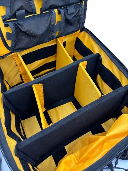 Close-up of the yellow-lined interior showing Velcro-mounted black foam divider walls creating customizable compartments