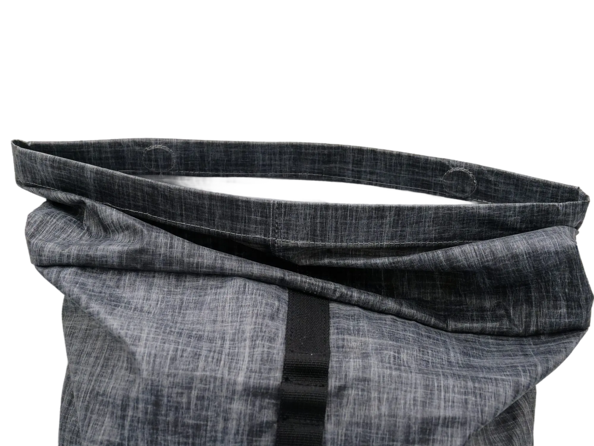 Close-up of the partially folded rolltop closure showing the Dyneema fabric texture and black webbing closure strap
