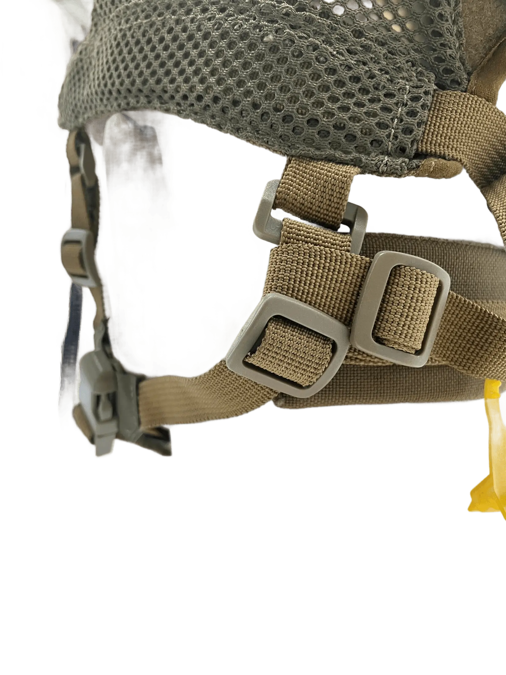 Close-up of the chin strap adjustment hardware showing tan webbing, dual metal loops and reinforced mesh base panel