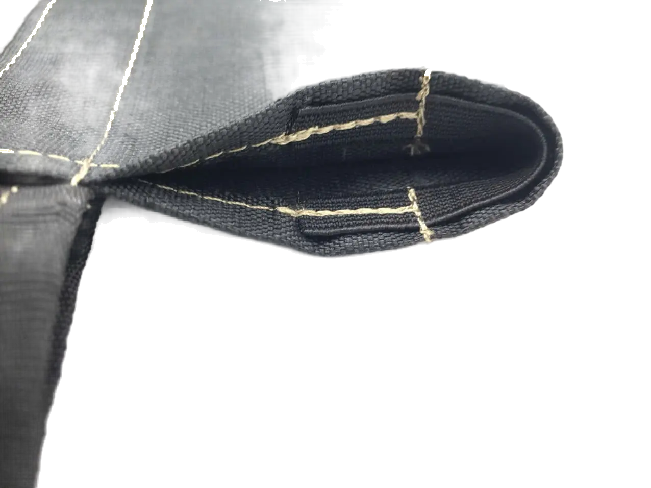Close-up of a reinforced pole sleeve corner showing heavy-duty stitching on black ripstop fabric