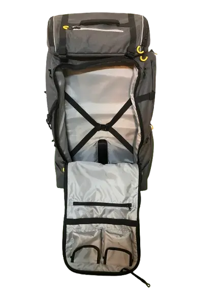 Front view with lower door open showing X-pattern retention straps and grey zippered pockets in the lower compartment