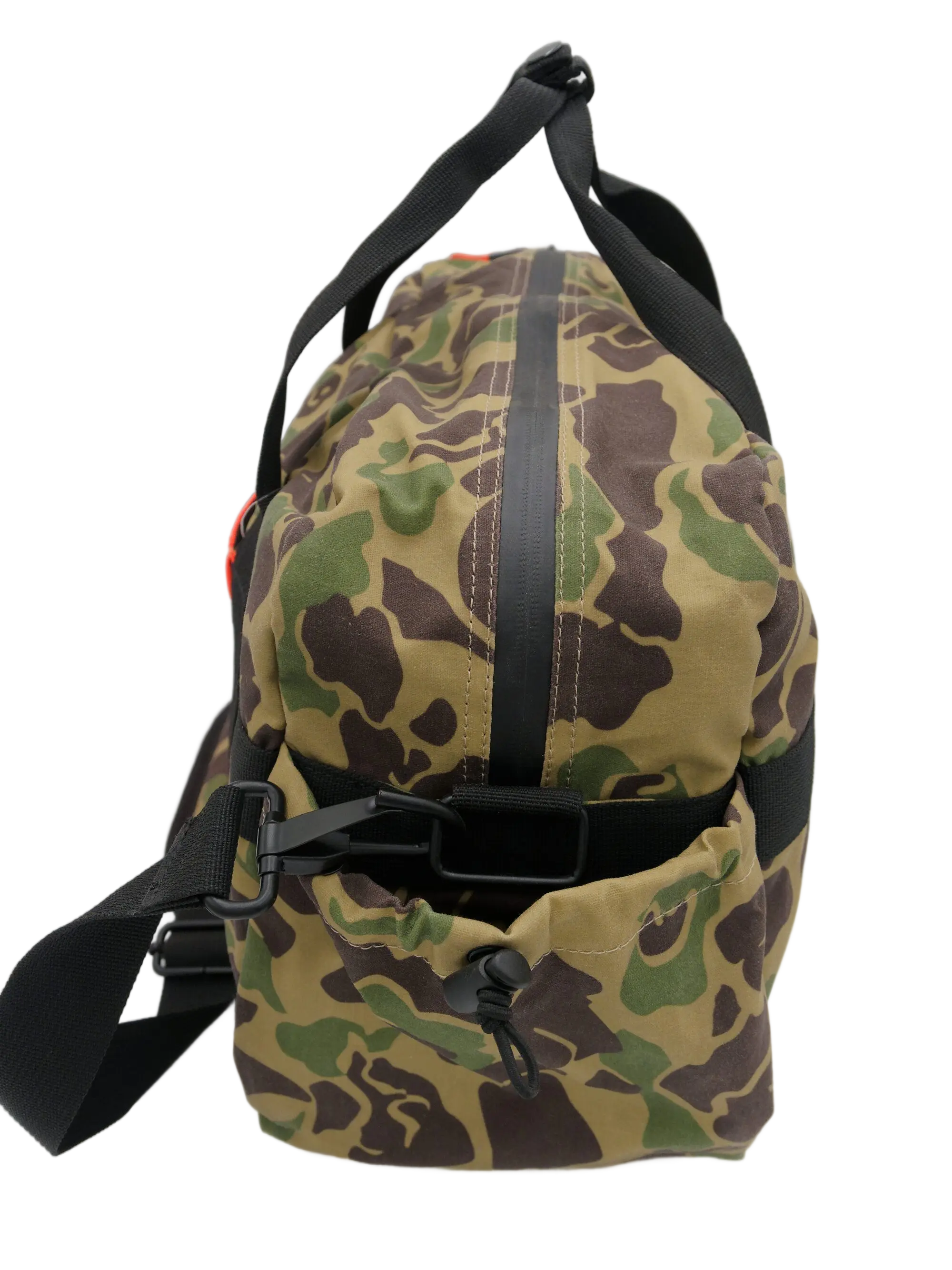 End panel view of the camo duffle bag showing black webbing strap, clip attachment hardware, and canvas construction