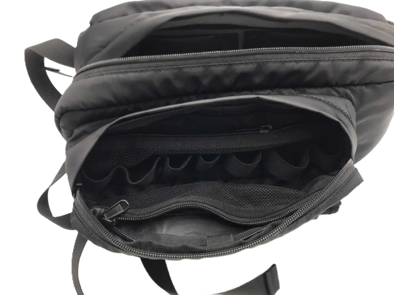 Open front organizer pocket of the black sling pack showing elastic loops for small accessories and a lower zip compartment