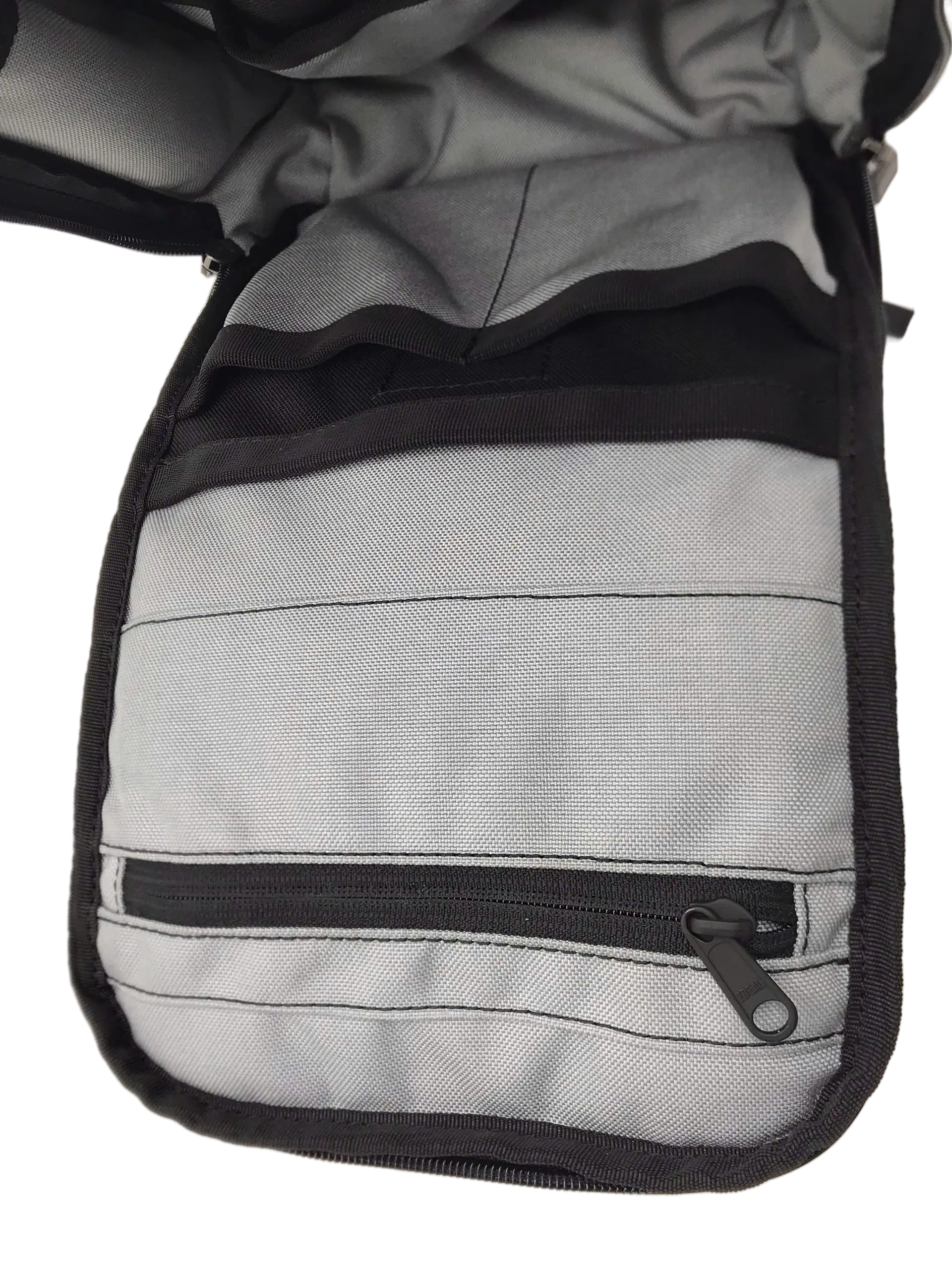 Interior pocket panel with grey lining, horizontal stitched dividers, and a zip compartment at the base