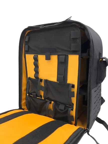 Open top section of the tactical backpack with yellow lining and black webbing organizer straps visible
