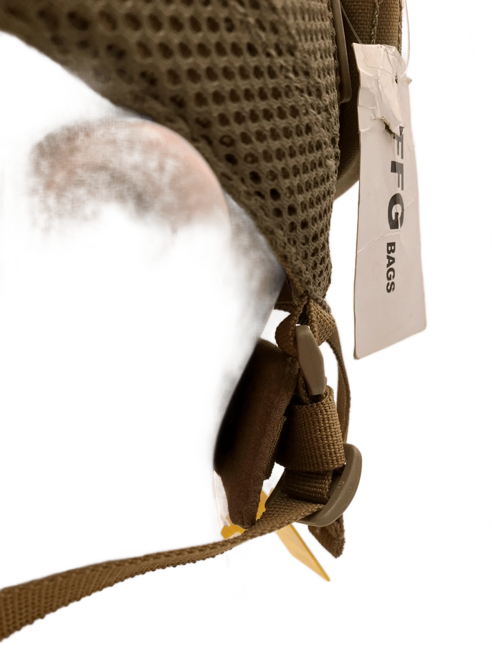 Side close-up of the head mount showing FFG Bags label, tan mesh exterior, and chin strap buckle connection point