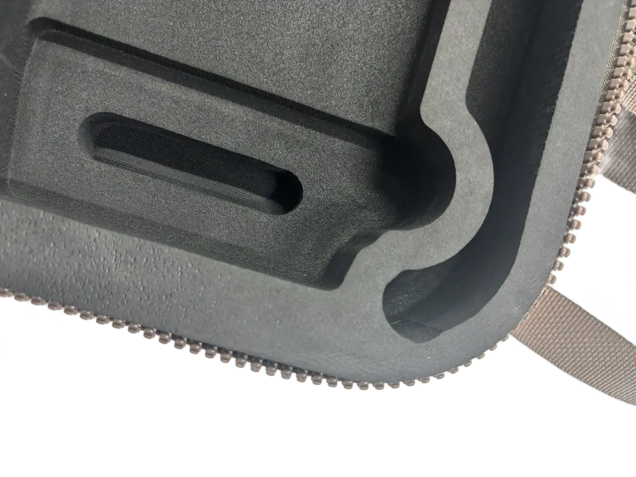 Grey EVA foam insert detail showing rectangular slot and shaped cutout for drone body component protection