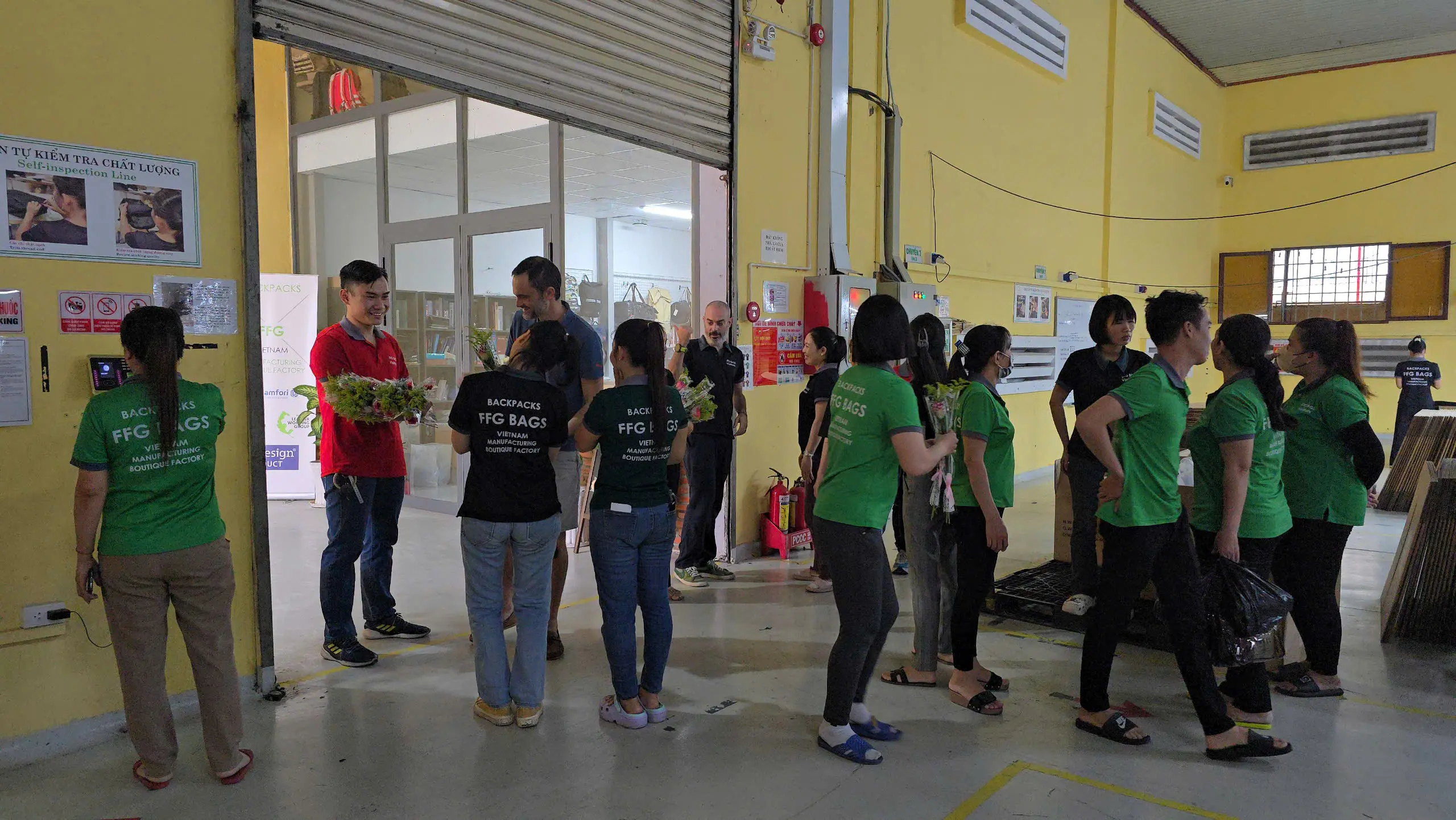 FFG Bags team members gather indoors for Women's Day celebration, many wearing green shirts