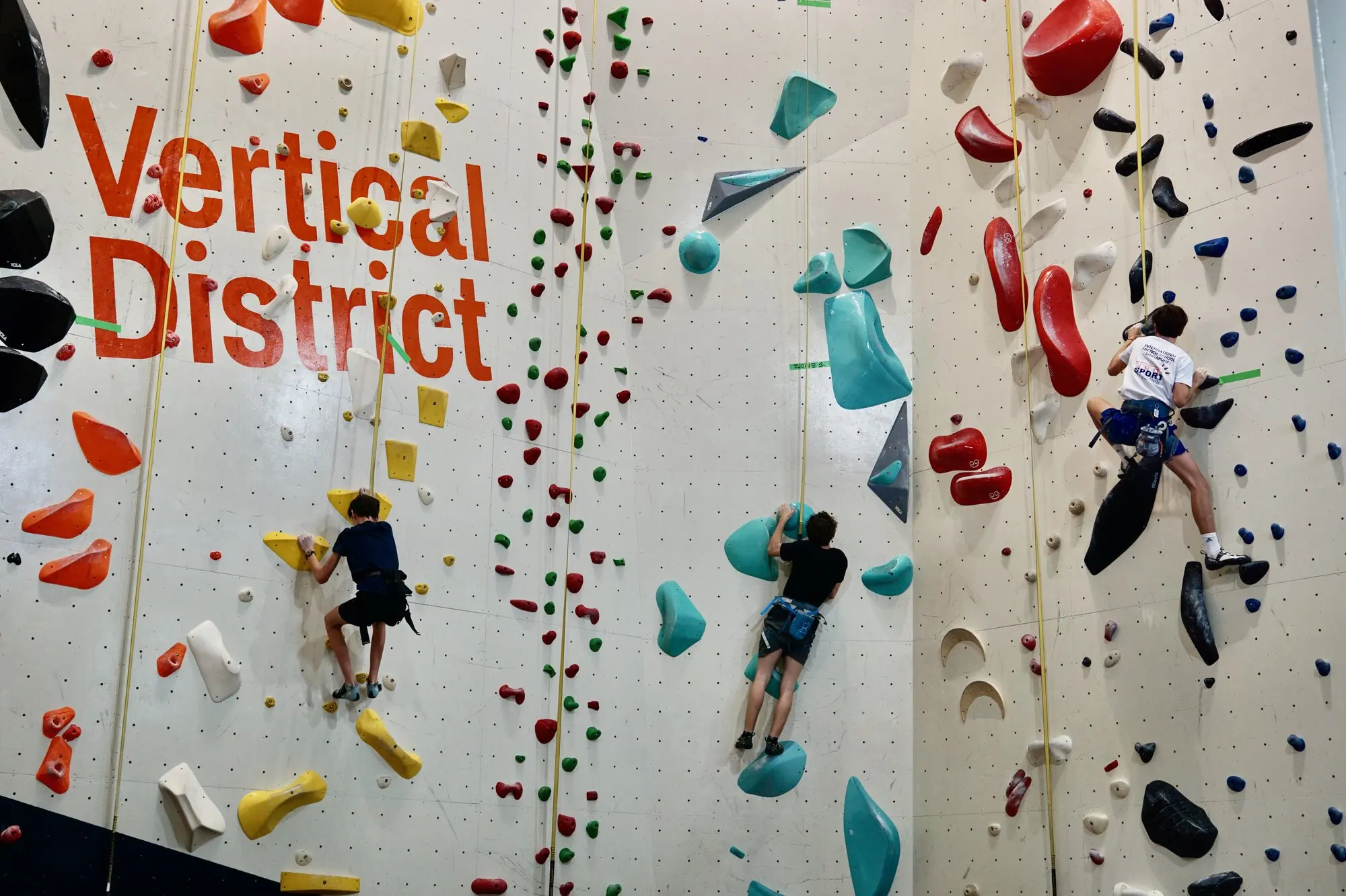 Climber wearing turquoise-trimmed FFG Bags utility pack with grey waistband over climbing harness