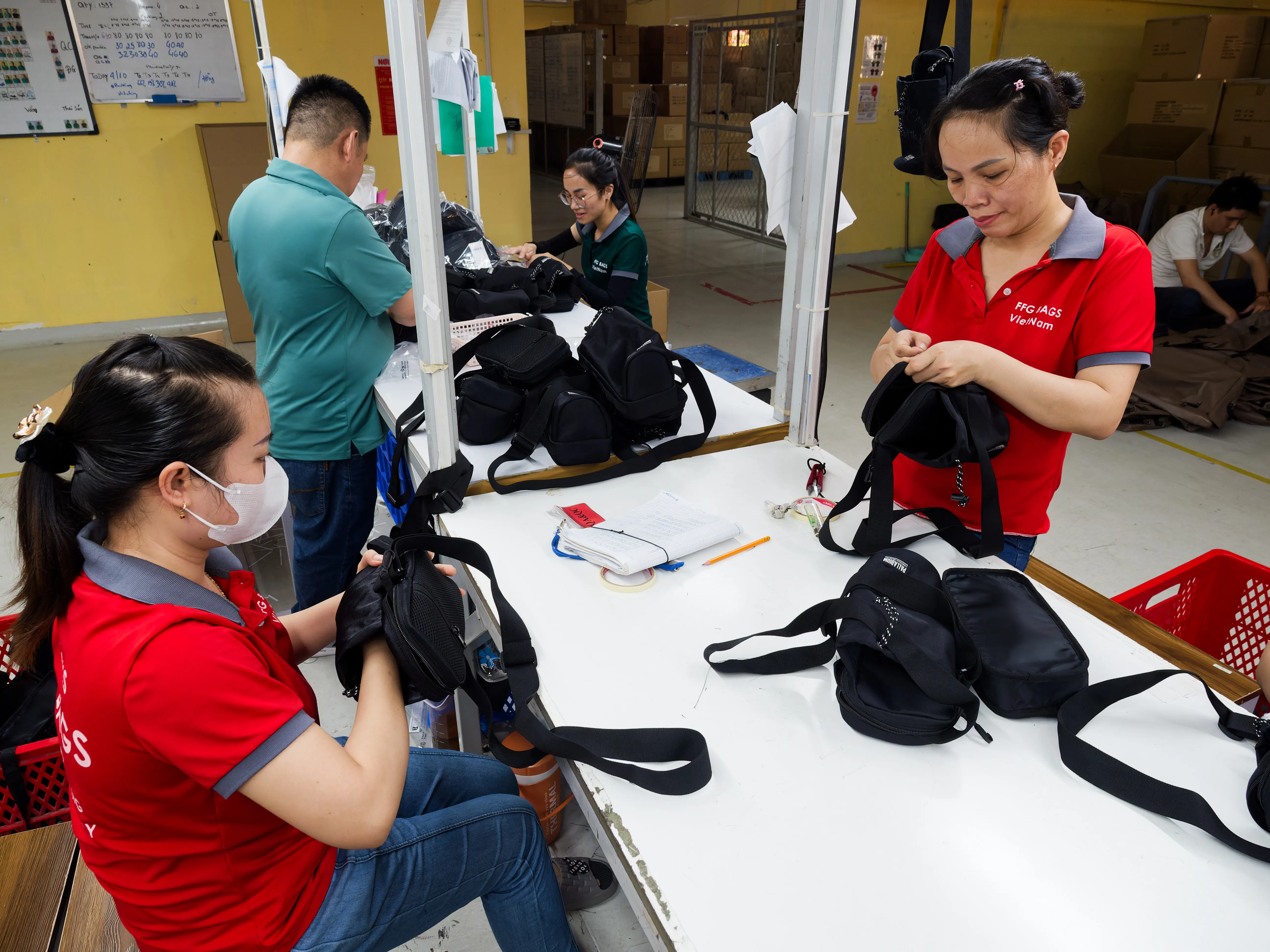 FFG Bags team checking and finishing black bags before packing
