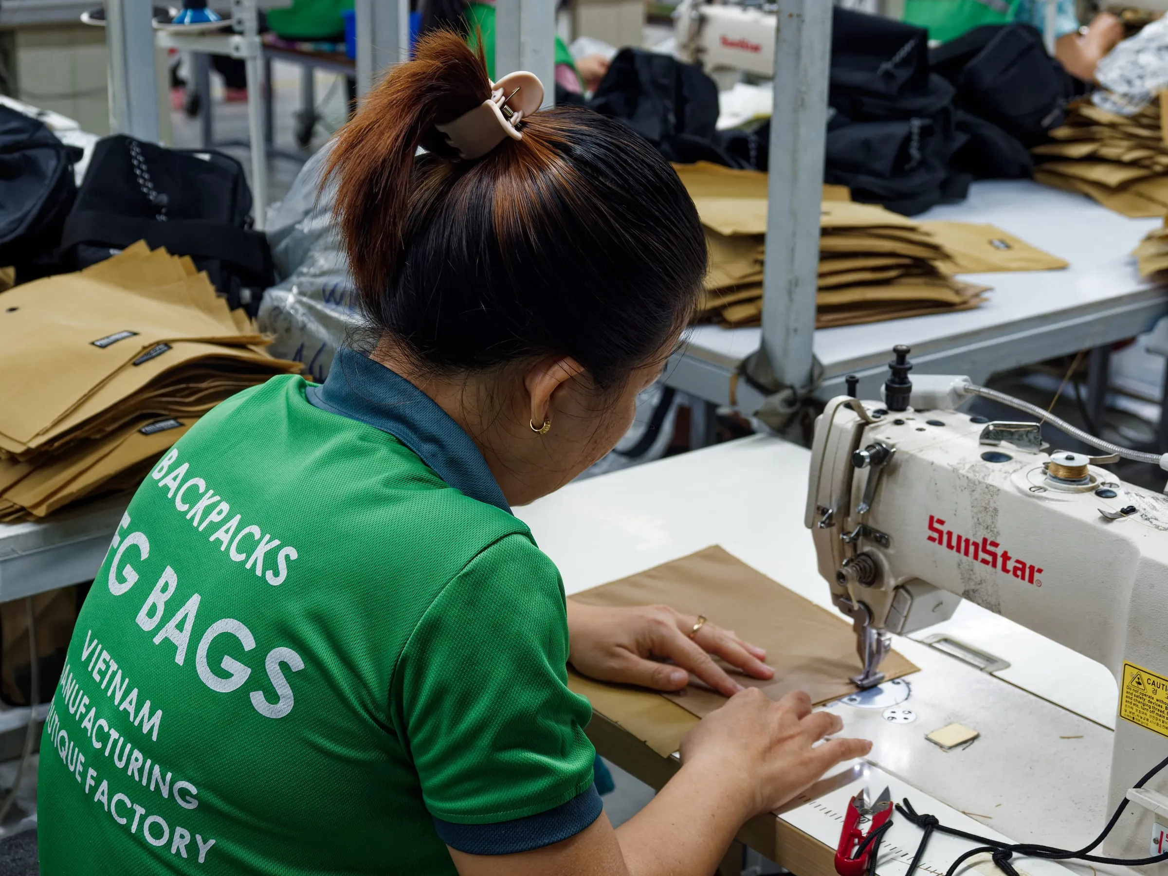 FFG Bags operator sewing tan bag panels during production