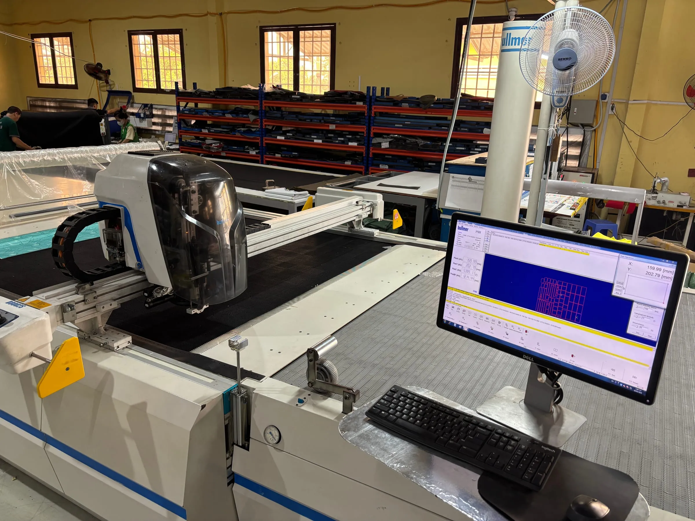 Bullmer automatic cutting machine preparing technical fabric panels at FFG Bags Vietnam
