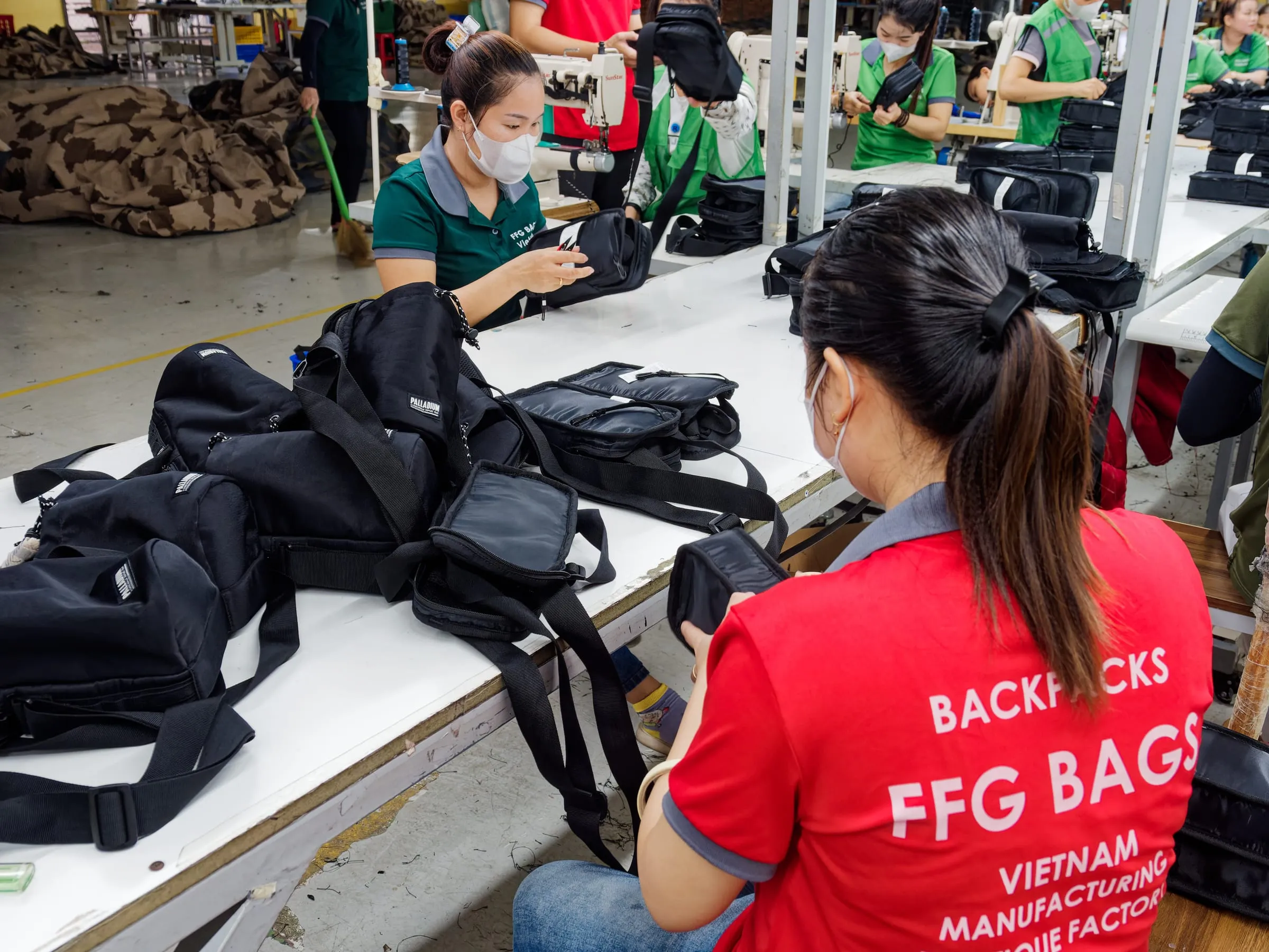 FFG Bags operators inspecting finished black bags on the production table