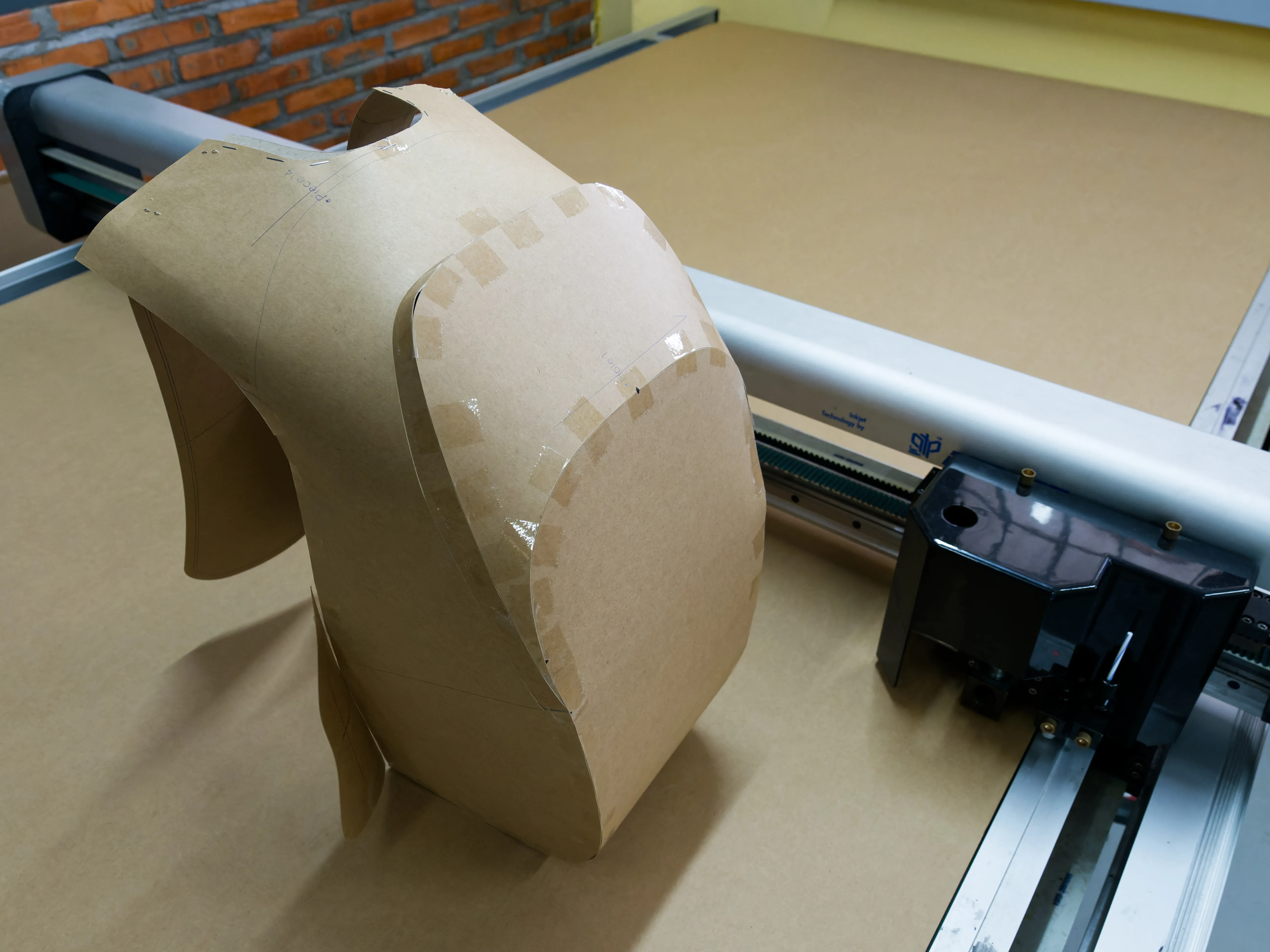 Three-dimensional paper bag pattern beside a digital cutting table at FFG Bags