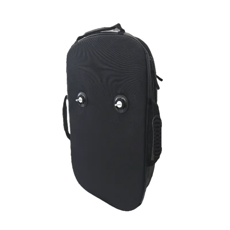 Front panel of the black ripstop wheelchair bag showing two chrome Fidlock attachment studs and ergonomic side handle